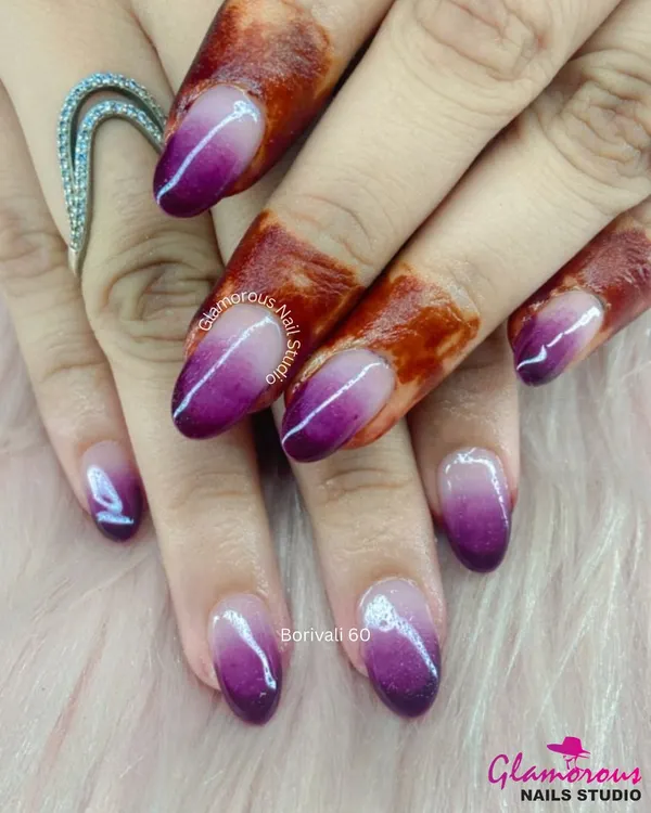 A stunning purple ombre. This design features a beautiful, seamless gradient from a deep, rich purple to a shimmery, pearlescent white, creating a look that is both bold and elegant.
