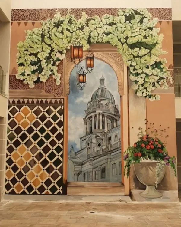 For a clubhouse in Nambiar Bellezea, we created this stunning, large-scale mural to evoke the charm of a Spanish boulevard. The artwork features a grand doorway, sun-kissed architecture, and lush flowers, creating a perfect photo opportunity.