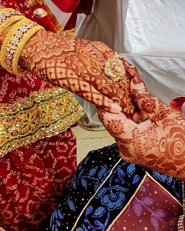 This is what I call stain goals. The deep, rich color of the henna is beautifully captured in this photo, showing the intricate patterns holding hands.