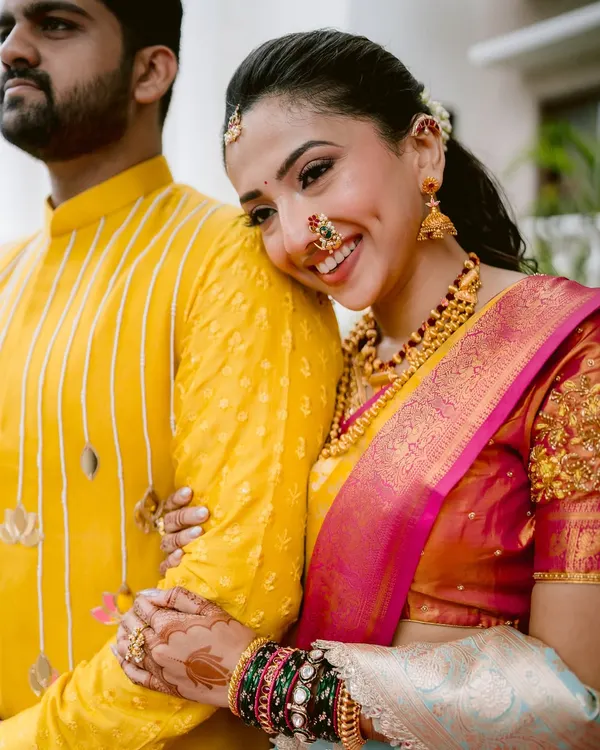 Maithili's radiant smile says it all. This close-up from her engagement in Satara highlights the intricate beauty of her traditional Maharashtrian jewelry and the sheer happiness of the moment.
