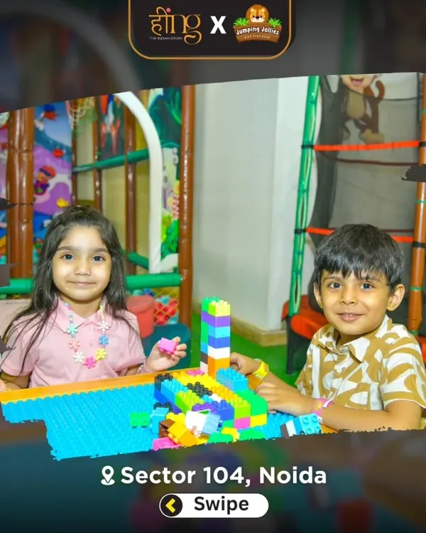 Creative minds at work in our toddler zone. These two are building towers with our large, soft building blocks, a perfect activity for developing fine motor skills.