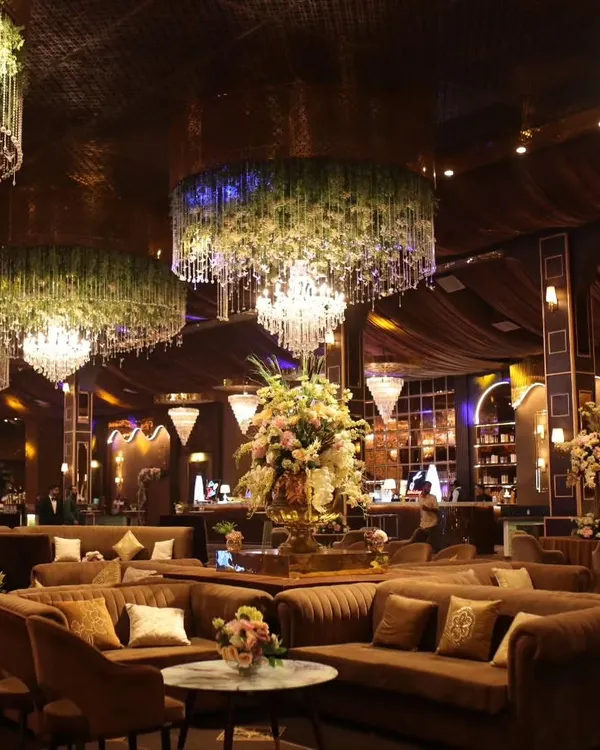 I believe the setting is just as important as the menu. Here is a look at a luxurious lounge area I catered for, where elegant decor with floral chandeliers and comfortable seating created a truly sophisticated ambiance for guests.