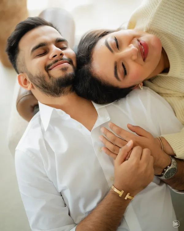 A moment of complete peace and togetherness. This overhead shot from a cozy indoor pre-wedding session captures the feeling of finding rest and comfort in each other's arms.