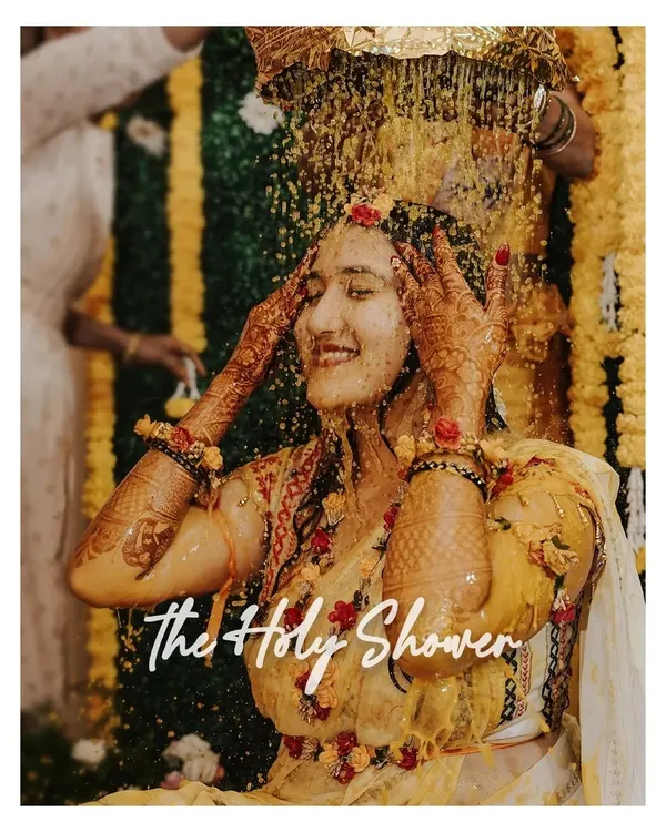 A blissful moment under 'The Holy Shower' of turmeric and flowers. We capture the peak of the Haldi ceremony with all its energy and tradition.