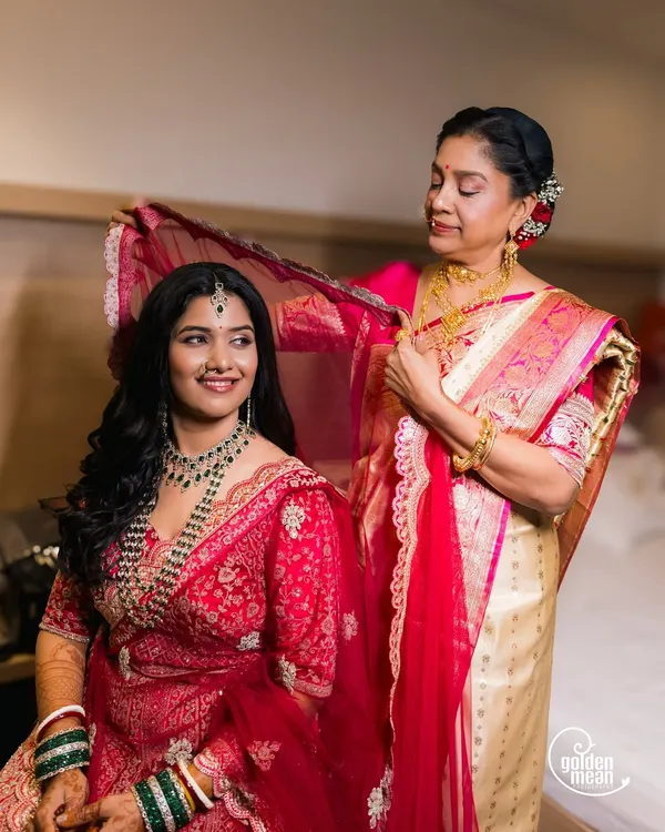 A mother's gentle touch as she helps her daughter with her veil. These moments between family are priceless.