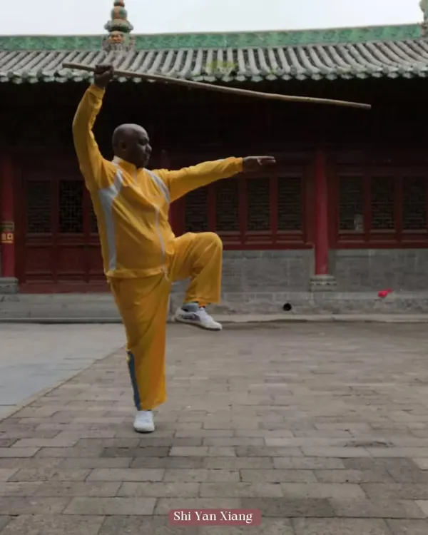 Pictured here during my training at the Shaolin Temple. This is a classic staff posture, which builds balance, strength, and coordination. The staff is a foundational weapon in Shaolin Kung Fu.
