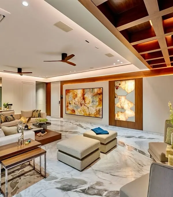 This living room is a masterclass in balancing scale and comfort. We used a coffered wooden ceiling to add warmth and architectural interest, while the expansive Satvario marble flooring provides a luxurious foundation for the neutral-toned, plush furniture.
