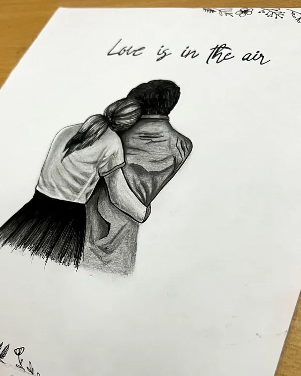 A detailed pencil drawing of a couple sharing an embrace, framed by a delicate floral border. This romantic sketch is a beautiful way to capture love and makes for a personal anniversary or wedding gift.