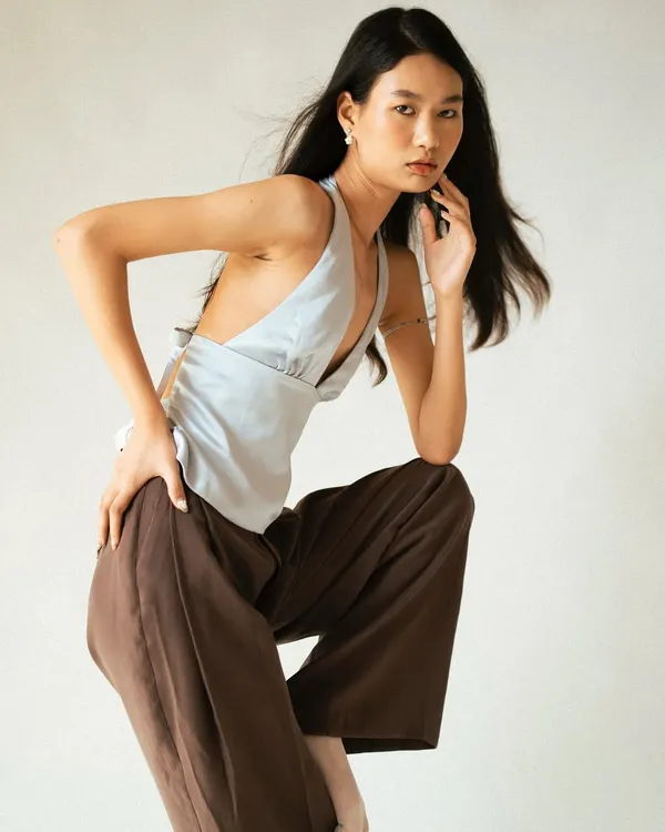 A dynamic pose against a clean studio background, perfect for a model's portfolio to show movement and form.