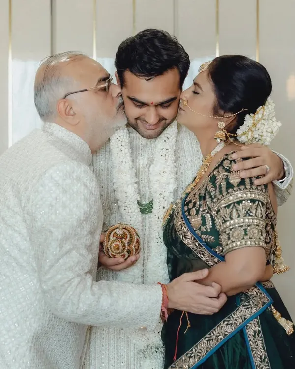 The purest form of love. The groom receives kisses from his proud parents on his wedding day. These are the moments that fill our hearts.