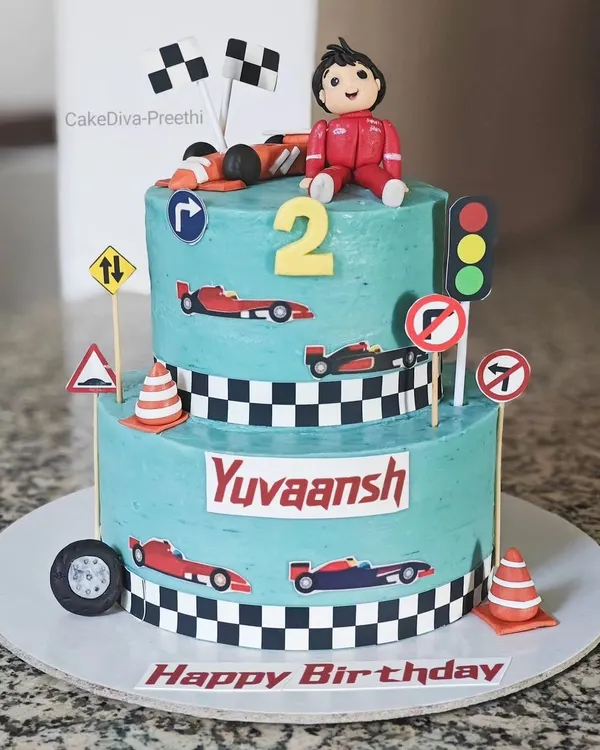 Growing up "two" fast, too curious! This two-tier red velvet ganache cake was for a race car-themed second birthday, complete with fondant cars, traffic signs, and a checkered flag pattern.