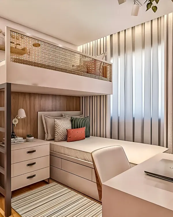 This is how we make a small bedroom work for both rest and productivity. We designed this custom loft bed with an integrated desk and storage unit below, creating a complete living solution in a minimal footprint. The light color palette and cane details keep the space feeling airy and open.