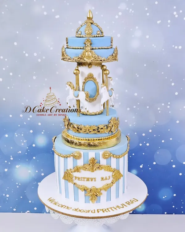 A magnificent carousel cake to celebrate one month of baby Prithviraj. This three-tier creation in blue, white, and gold is a dreamy centerpiece for a first milestone.