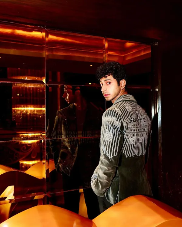 Mihir Ahuja in my grey velvet coat, a piece defined by its intricate hand embroidery. This back view shows the detailed craftsmanship that covers the shoulders and sleeves, creating a wearable work of art.