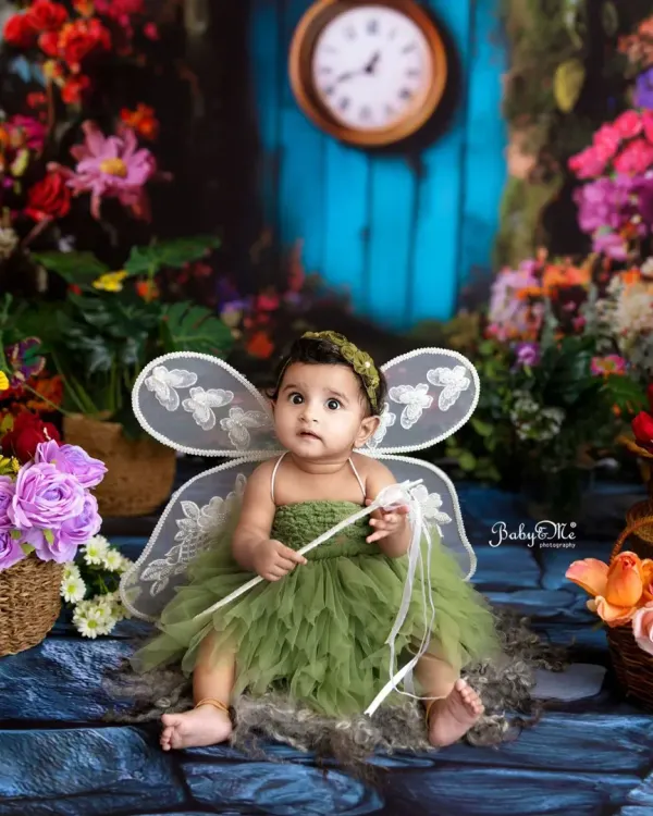 This little fairy is ready to spread her magic. Dressed in a green tulle outfit with delicate wings, she looks right at home in my enchanted garden setup.