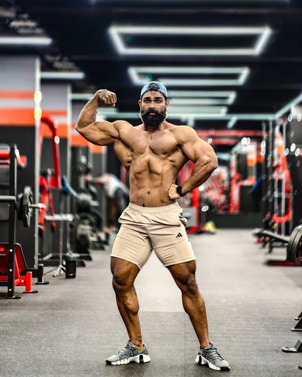 A classic physique pose showcasing overall symmetry, muscle mass, and conditioning. This is the standard I work towards, balancing size with aesthetics. I help coaches understand how to build a complete and balanced physique.