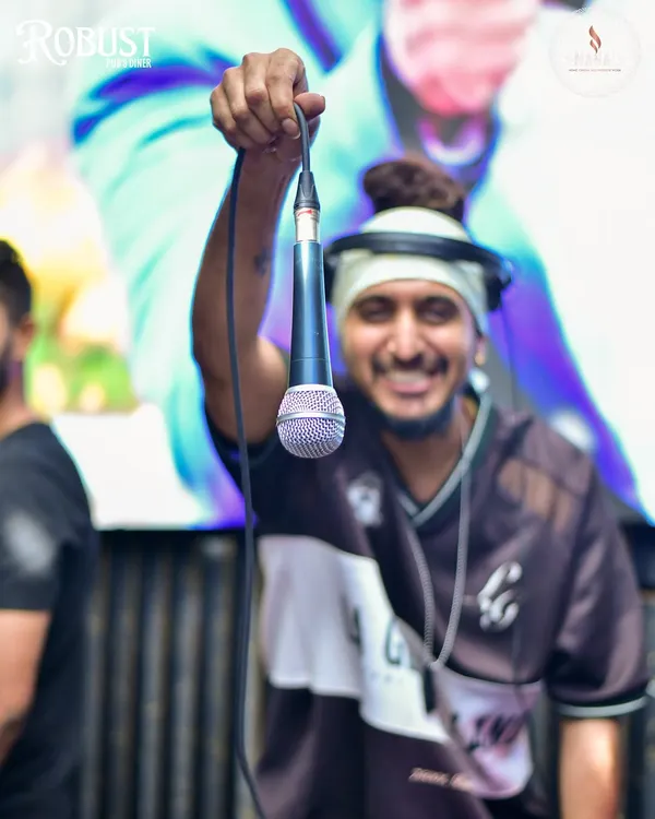 Holding out the mic to the crowd. This shot captures my interactive style and my goal to turn every night into a mini-concert.