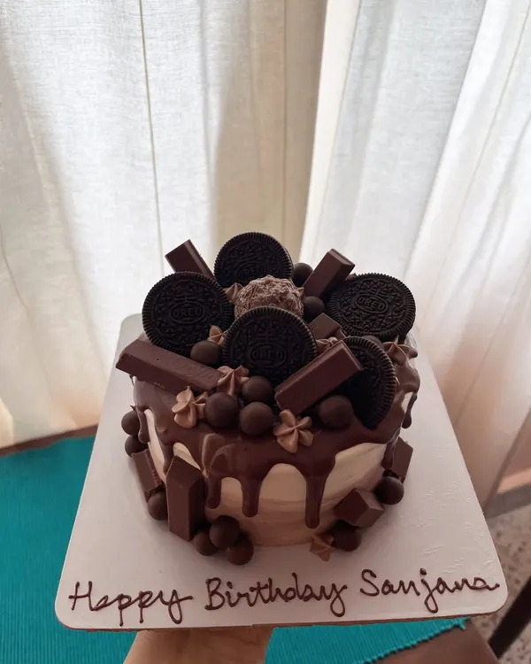 The ultimate chocolate overload cake. This 5-inch chocolate sponge is covered in dark chocolate ganache and loaded with Oreos, KitKats, and other chocolate treats.