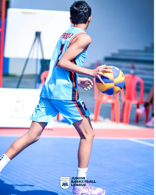 A young player dribbling with precision during a Junior Basketball League game. I focus on creating opportunities for young athletes to showcase their fundamental skills.