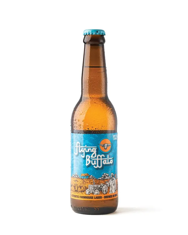 This is a perfect example of a clean, high-quality e-commerce shot for Flying Buffalo beer. The crisp white background, perfect condensation, and clear lighting make the product look professional and refreshing.