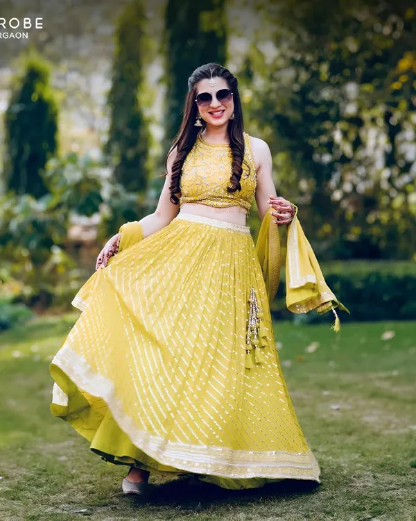 This happy client is glowing in a bright yellow lehenga, rented for her Haldi ceremony. It’s the perfect outfit to shine bright during your festivities.