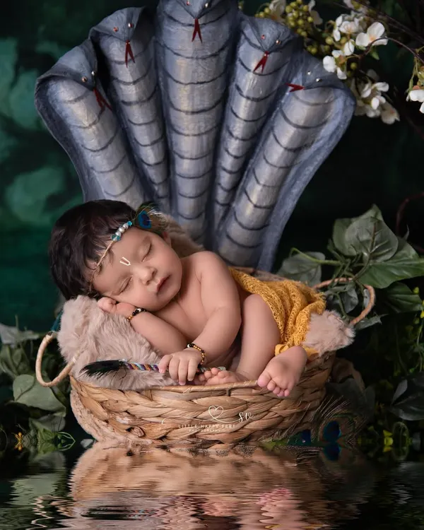This powerful portrait of our little Kanha resting under the protection of Sheshnag is one of my favorites. I work with talented artisans to create custom props that bring these divine stories to life with authenticity and beauty.