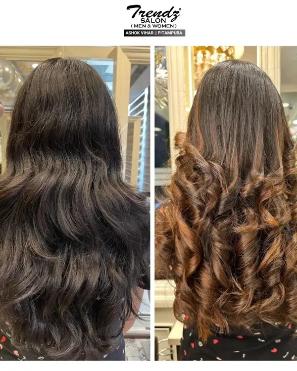 A classic before-and-after that shows the impact of well-placed highlights. We transformed this client's dark hair by adding warm, caramel tones and styling it into bouncy curls.