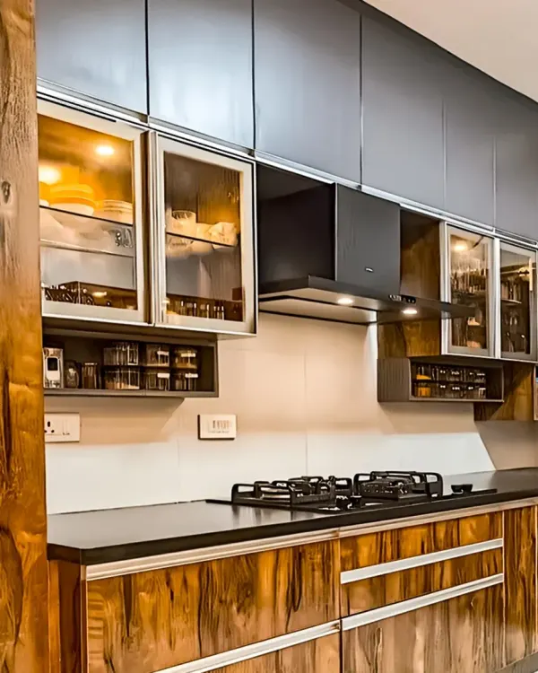 This kitchen showcases the beauty of a rich, dark wood grain on the cabinets. Paired with matte black uppers and glass-fronted display sections, the look is both rustic and modern.