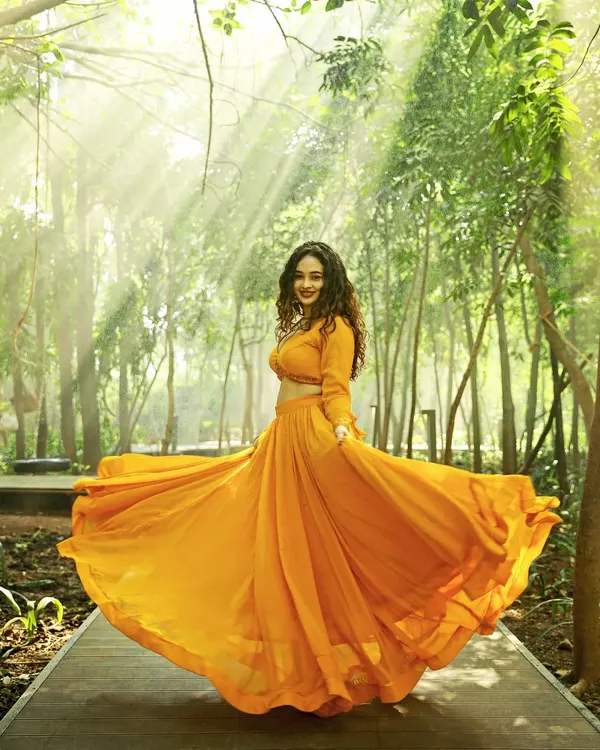 I love capturing the energy of an outfit in motion. For this outdoor fashion shoot, we used the golden hour light to make this flowing orange lehenga pop against the greenery, creating a dramatic and memorable image for the brand's lookbook.