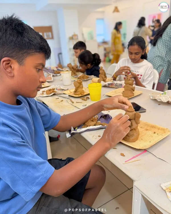 A young boy completely absorbed in sculpting his own Ganesha idol from clay. Our clay workshops are a fantastic, tactile experience for kids.