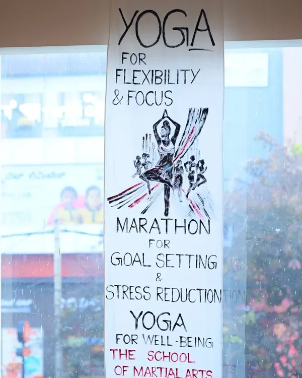 A handmade banner for our Yoga and Marathon programs, highlighting their benefits for flexibility, focus, and goal setting. We believe in a holistic approach to wellness that complements martial arts training.