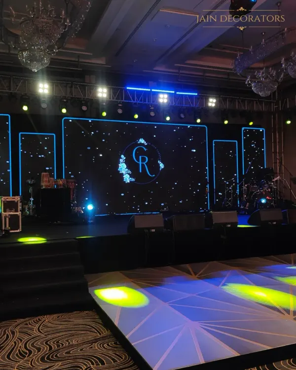 I designed this sangeet stage for a full-on concert experience. A massive LED screen displays custom graphics, flanked by professional lighting rigs and a stage ready for live performances, ensuring a night of high energy.
