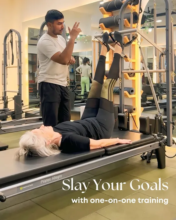 Your goals, our mission. With one-on-one training, we tailor every session to you, like helping this client perfect her leg presses on the Cadillac.