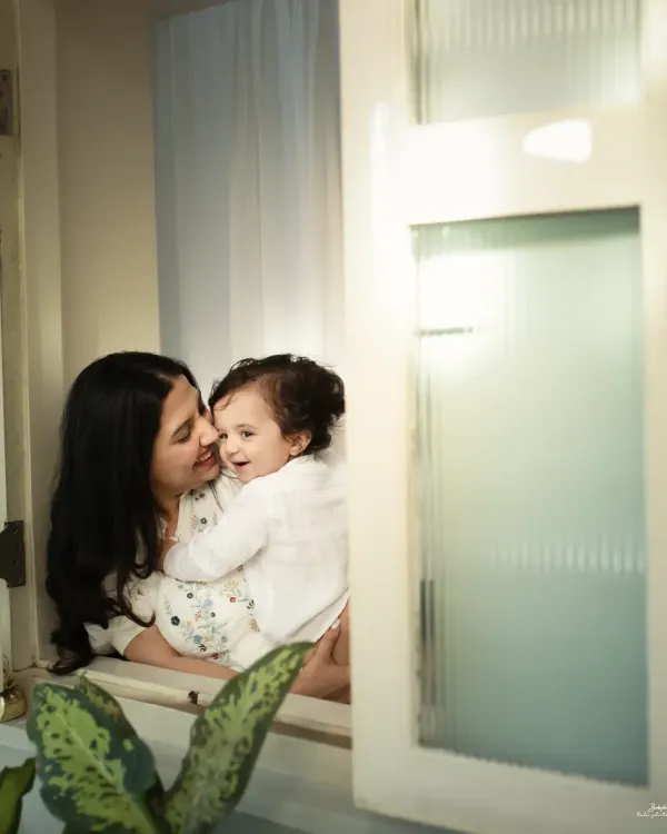 The pure love between a mother and her child. This candid moment by the window, filled with soft light and gentle smiles, is what I call a perfect memory.