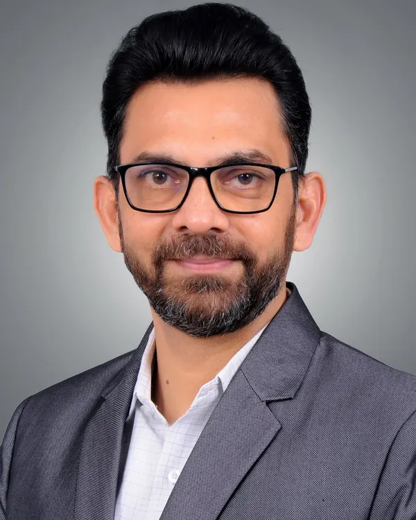 I create clean, professional headshots that build confidence for your corporate profile. This portrait uses a standard grey studio backdrop and precise lighting to create a sharp and approachable look, perfect for LinkedIn or a company website.