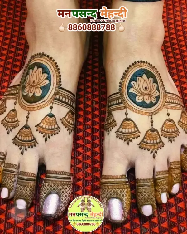 A unique and modern foot mehndi design featuring lotus mandalas and hanging jhumki (earring) motifs. The use of color makes this design truly stand out.