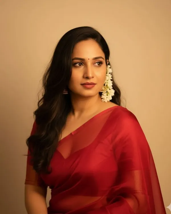 A beautiful, soft, and elegant look I created. The client is wearing a simple red organza saree with jasmine flowers in her hair, a timeless and classic style.