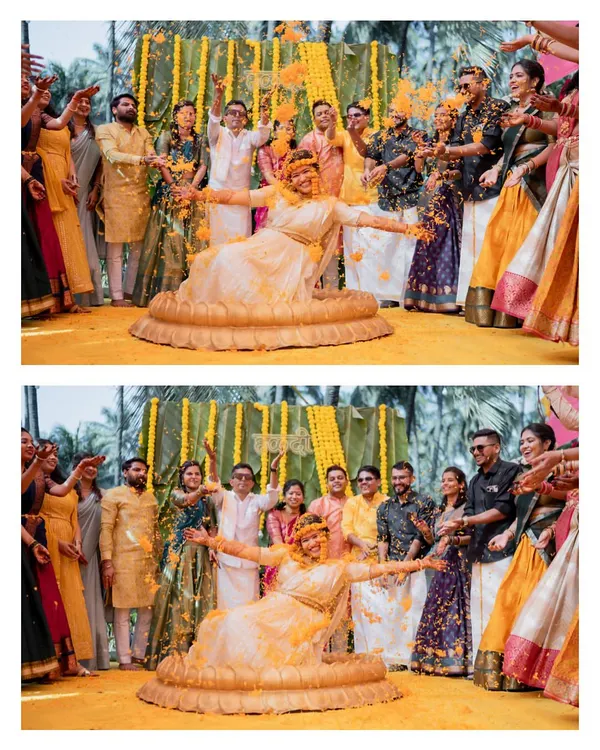 The quintessential Haldi moment. The bride is showered with marigold petals by her family and friends in a joyous celebration.