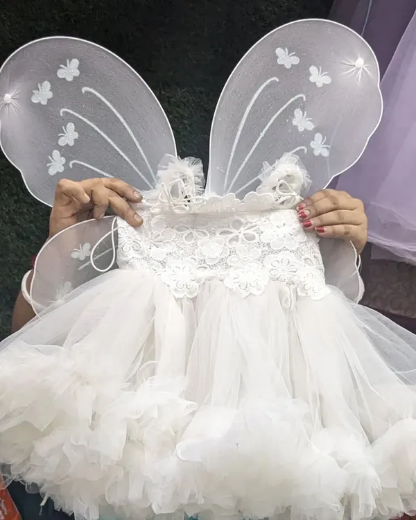 This adorable white baby frock comes with detachable butterfly wings. The top is made of soft cotton to ensure your little angel is comfortable all day long.