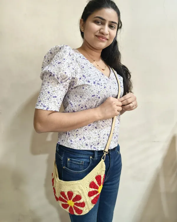 Here I am modeling my Groovy Daisy crossbody bag. It's a fun, retro-inspired design that's perfect for everyday wear, and I love how the bright floral granny squares pop. This handmade bag is lightweight and can be worn as a sling or a fanny pack.