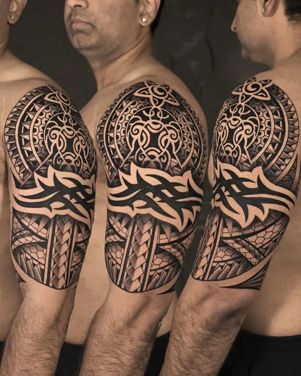 A powerful Polynesian-style half-sleeve. This piece is a perfect example of our expertise in tribal tattoos, featuring bold lines, intricate geometric patterns, and a design that flows with the body's natural form.