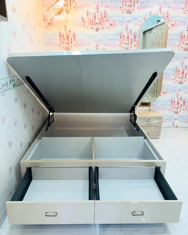 This image reveals the smart storage solutions built into our custom beds. This model features both easy-access front drawers and a large hydraulic lift-up compartment, maximizing under-bed storage space.
