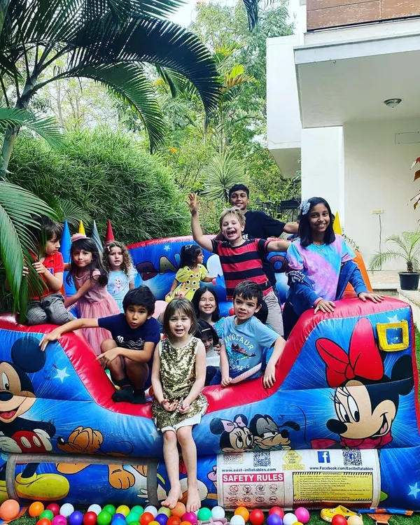 A perfect party moment filled with laughter and fun! I love seeing a group of happy munchkins enjoying a bouncy castle, a fantastic addition to any outdoor celebration.