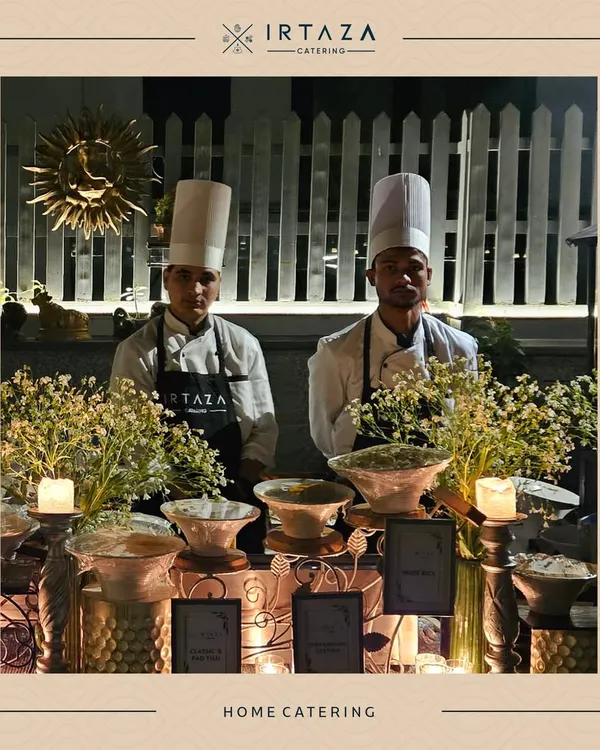 Two of my chefs in their full uniform, ready for service at a home catering event. Their professionalism is a core part of the Irtaza promise.