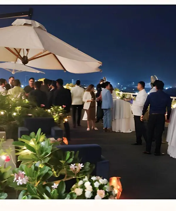 A beautiful night view of a rooftop party we catered, with guests enjoying the city lights. We excel at creating sophisticated atmospheres for evening corporate events.