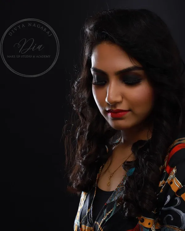 A beautiful profile shot showcasing a classic smoky eye paired with a vibrant red lip. This timeless combination is perfect for evening events and a fundamental style I teach all my students.