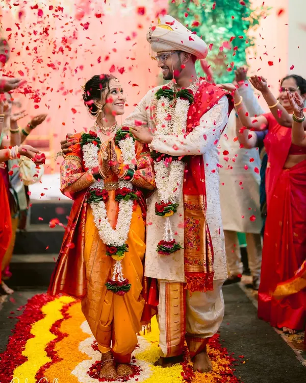 The moment the Antarpat is lowered, and they see each other as bride and groom for the first time, showered in akshata and blessings. A pinnacle moment of a Maharashtrian wedding.