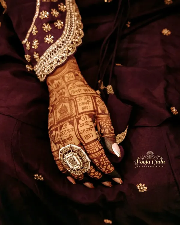 A close-up of a gorgeous, dark henna stain, showing how the intricate grid work and mantras stand out beautifully.