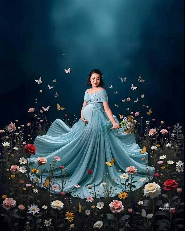 A truly magical portrait for the queen she is. We love creating these fantasy-inspired scenes, using flowing gowns and artistic effects like this field of flowers and butterflies to celebrate the wonder of motherhood.