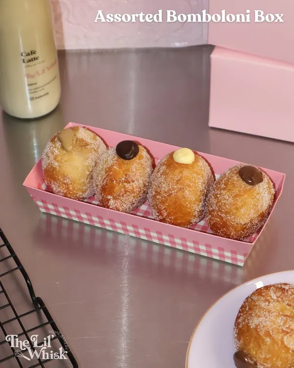 Our assorted Bomboloni Box is the perfect weekend treat. This box of four features fluffy, sugar-dusted Italian doughnuts filled with a variety of creamy custards and chocolates.
